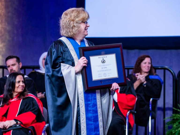 Ann Marie Vaughan holding framed degree