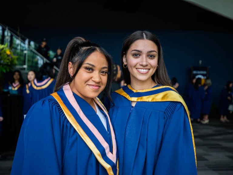 Two graduates posing for camera