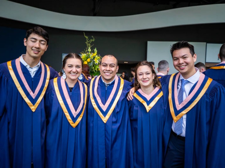 Five graduates take photo together