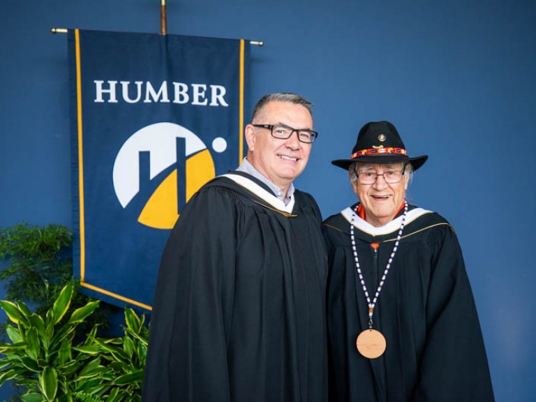 Honorary degree recipient Elder Albert Marshall takes photo with Humber inclusion leader Jason Seright