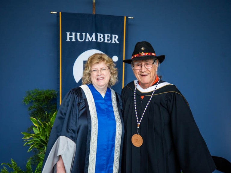 Elder Albert Marshall takes photo with Humber president Ann Marie Vaughan 