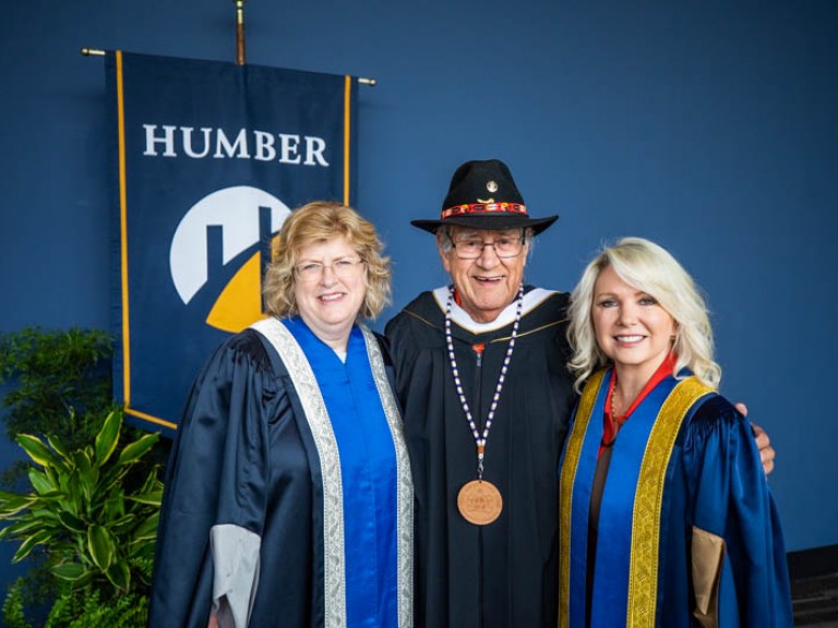Elder Albert Marshall takes photo with Ann Marie and another faculty member