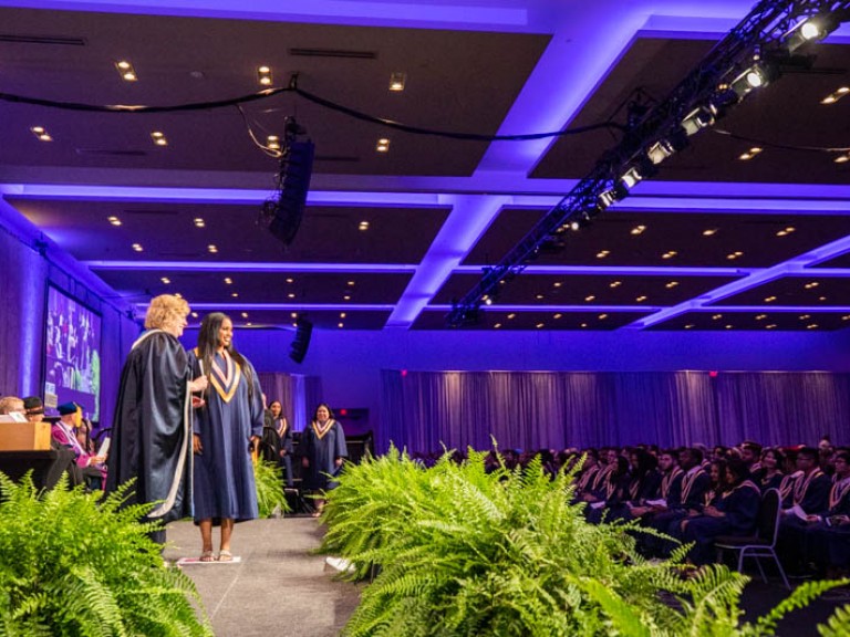 Graduate on stage with Humber president