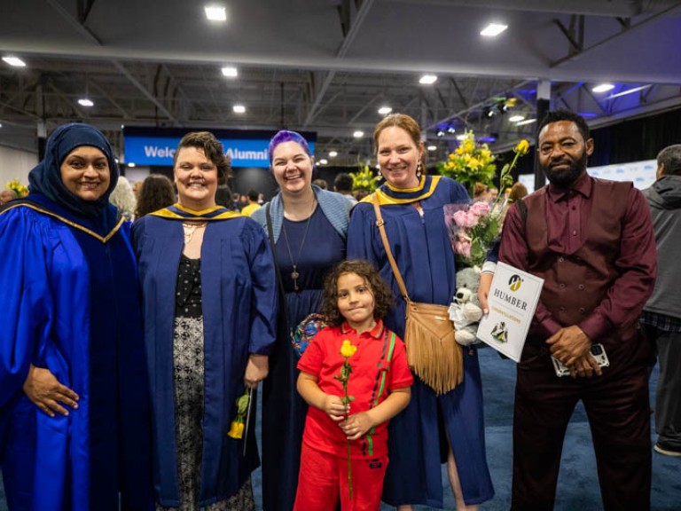 Graduates and guests pose for camera