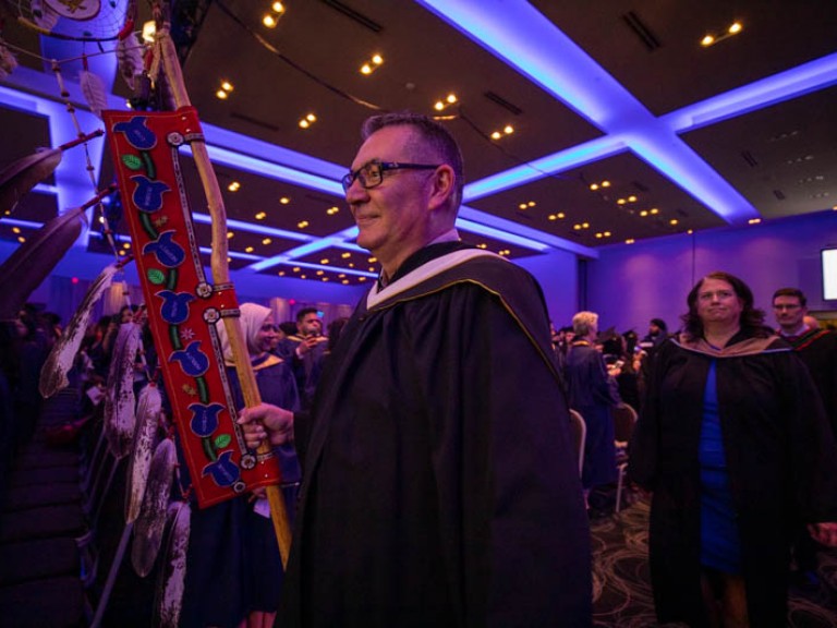 Humber faculty member carries Indigenous banner into ceremony hall