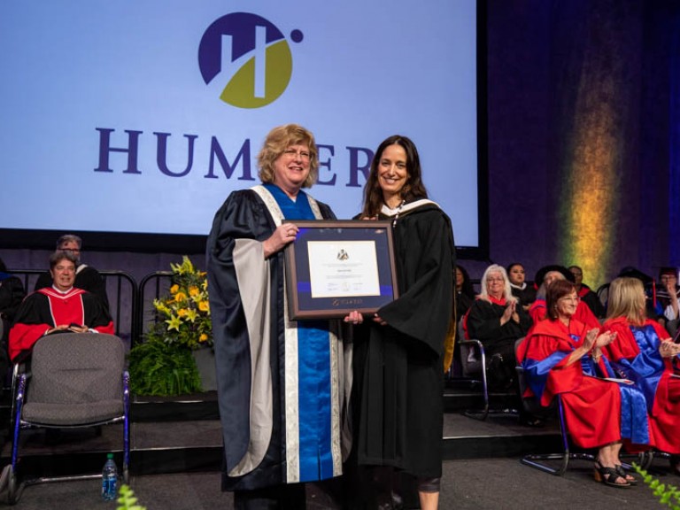 Chantal Kreviazuk and Ann Marie Vaughan pose for photo with framed degree held between them