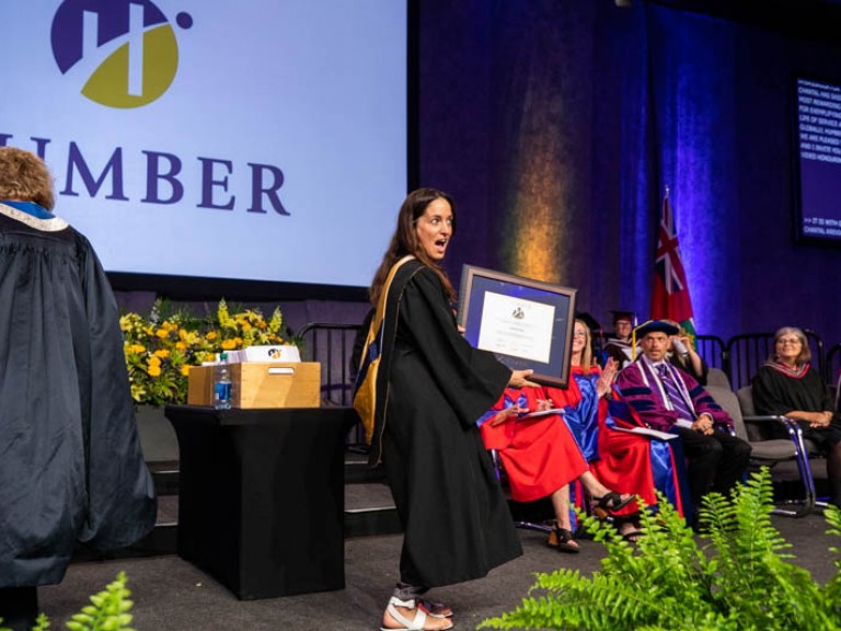 Chantal Kreviazuk holding degree with open mouth