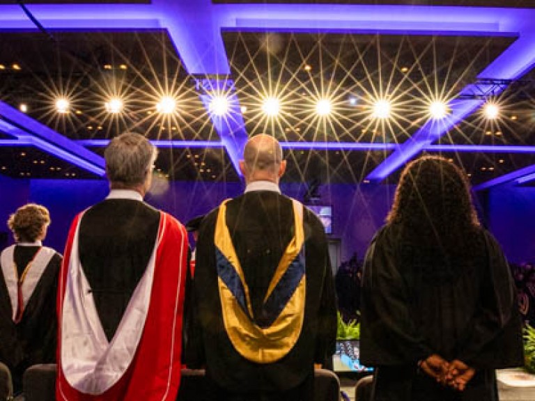 View of ceremony hall from behind people on stage