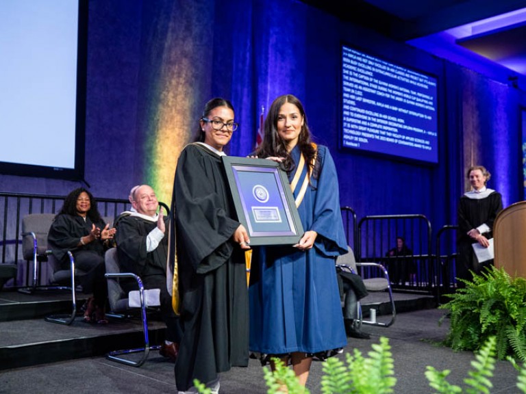 Award winner poses for photo with faculty member