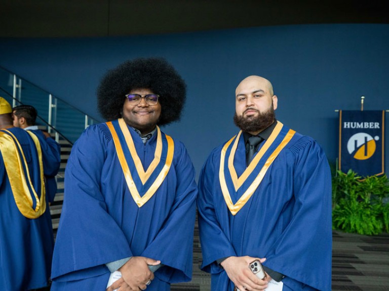 Two graduates take photo