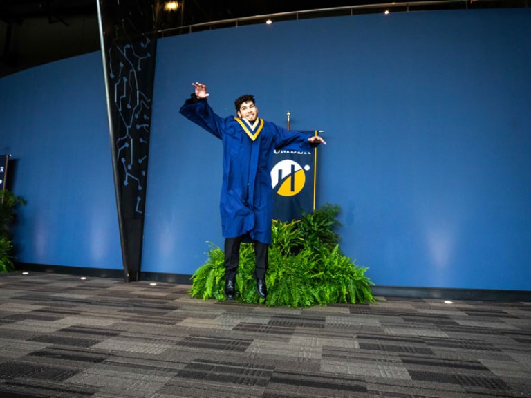 Graduate jumps in front of Humber flag