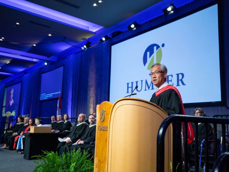 Person speaking the Humber podium on stage