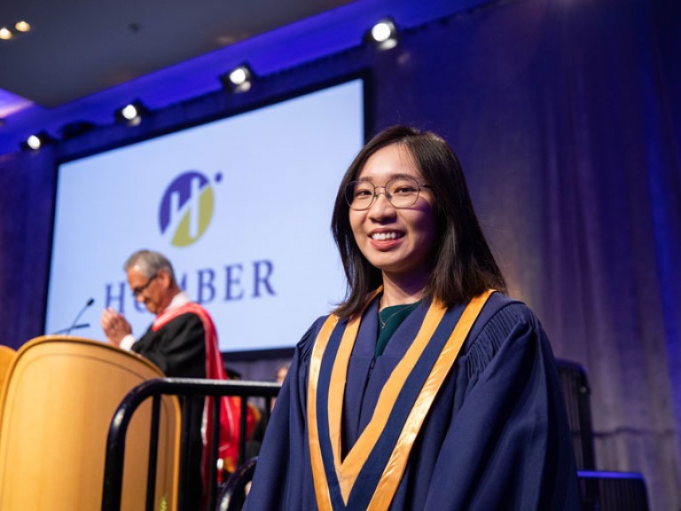 Award winner graduate smiles at camera