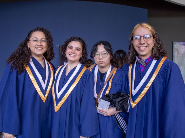 Four graduates posing for photo