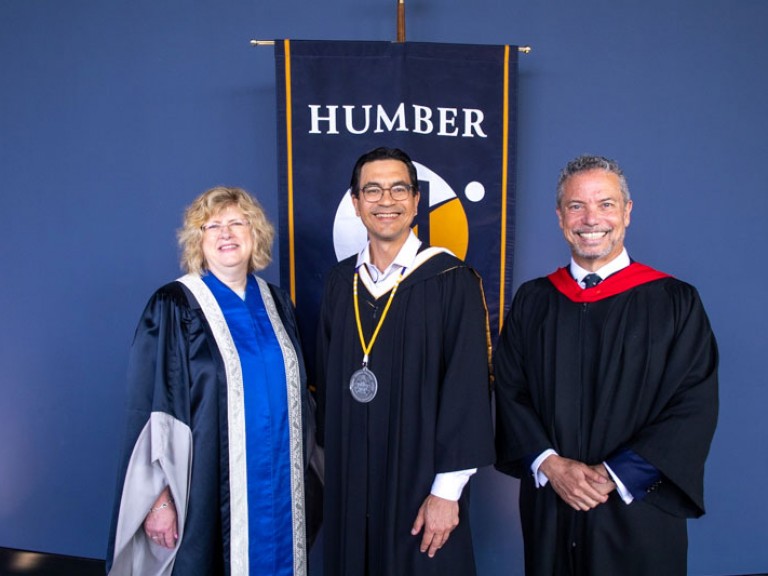 Three people including Humber president and honorary degree recipient pose for photo