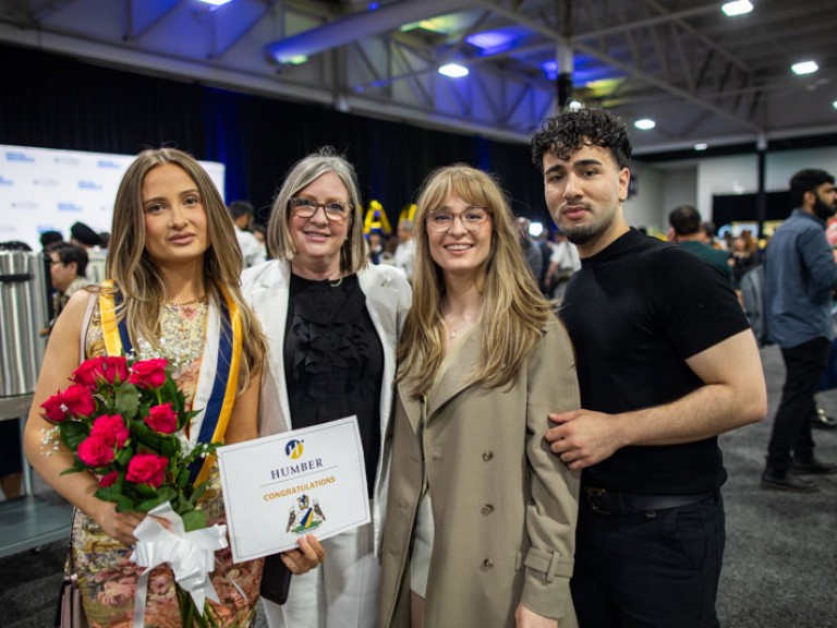 Graduate poses with family for photo