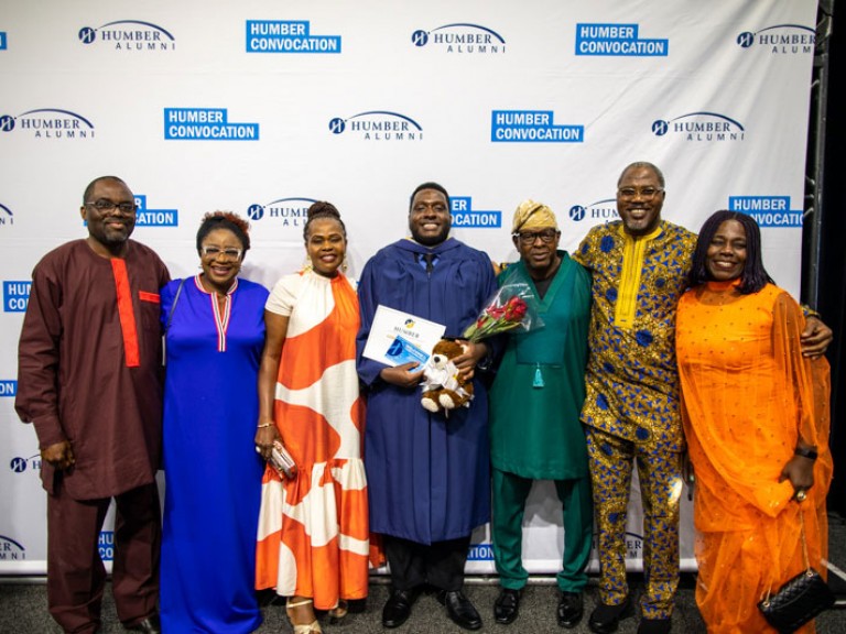 Graduate poses with six family members