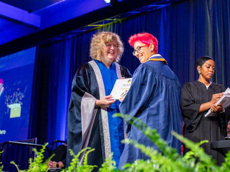 Graduate receives certificate from Humber president