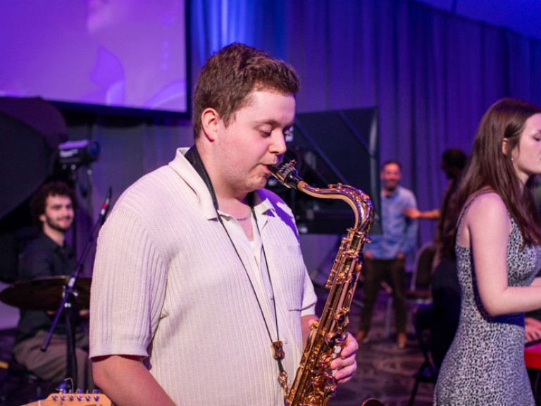 Person playing a saxophone on stage