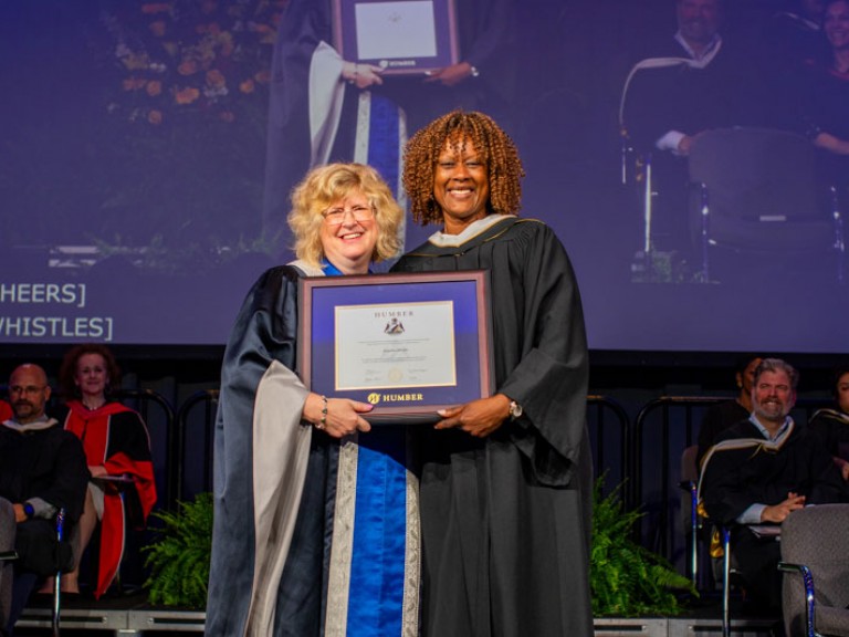 Honorary degree recipient Jacqueline Edwards accepts degree from Humber president Ann Marie Vaughan
