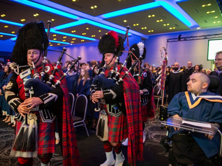 Bagpipe players enter the ceremony area