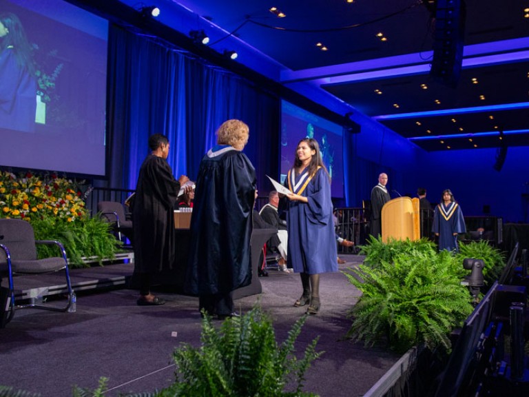 Humber president Ann Marie Vaughan on stage with graduate