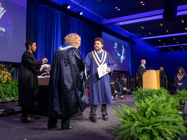 Graduate shakes Ann Marie's hand