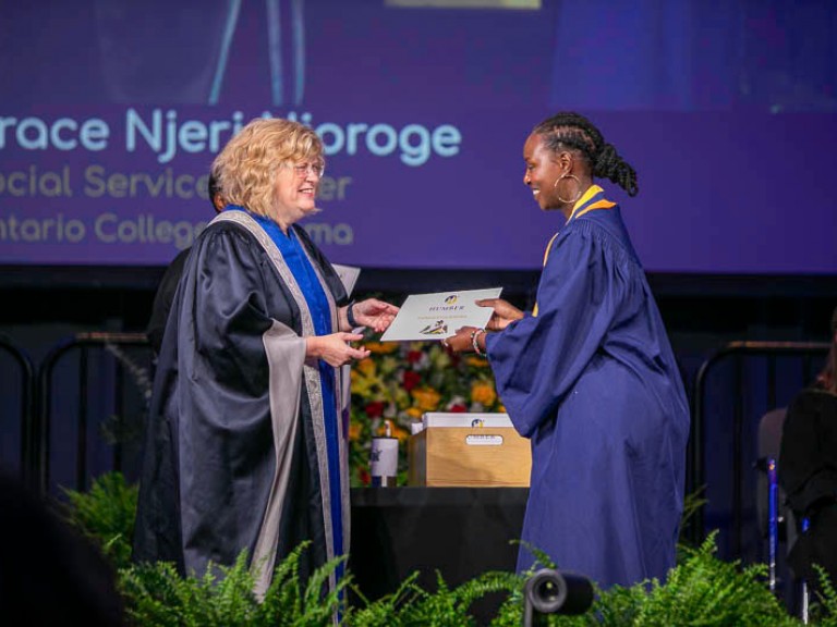 Graduate accepts certificate on stage