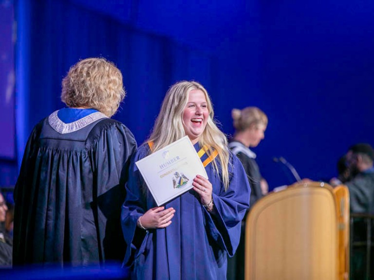 Graduate leaving stage with certificate