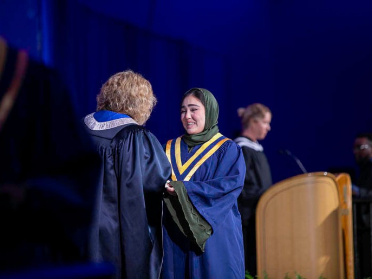 Graduate accepts certificate from Ann Marie Vaughan