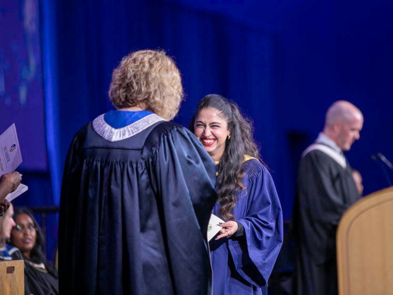 Graduate smiles on stage