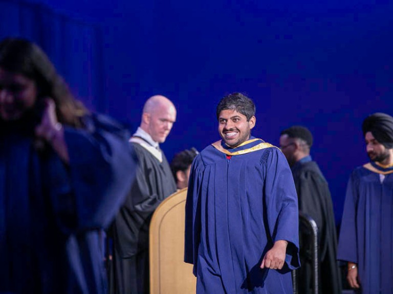 Graduate crosses stage to accept their certificate