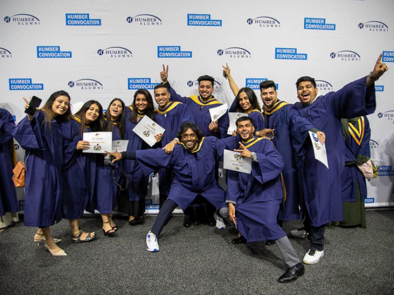 Eleven graduates take group photo together