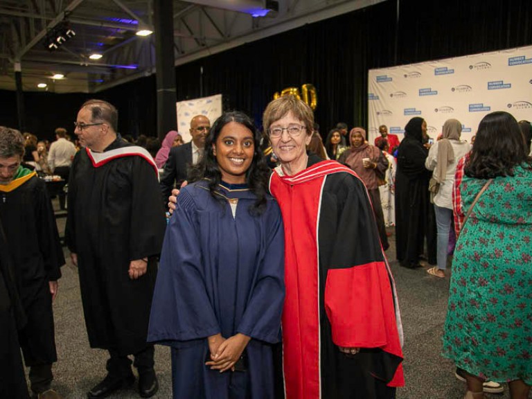Graduate takes photo with Humber faculty member