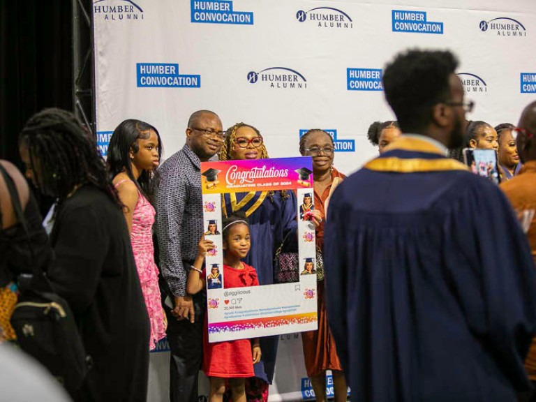 Graduate takes photo with family members