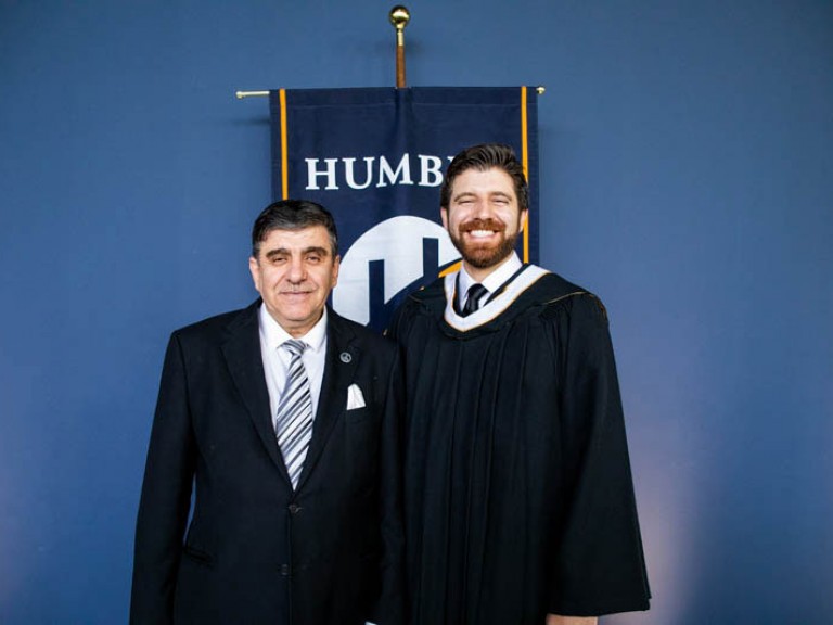 Honorary degree recipient Tareq Hadhad takes photo with a guest
