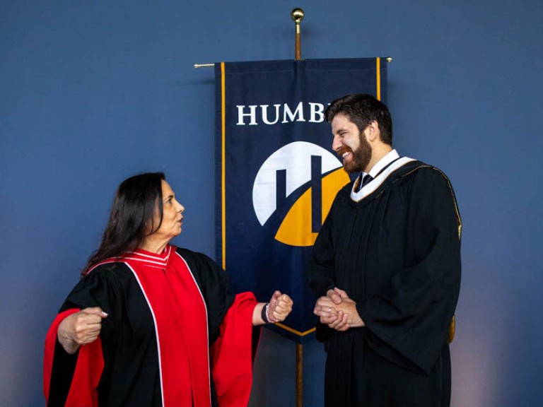 Honorary degree recipient Tareq Hadhad talking to a Humber faculty member