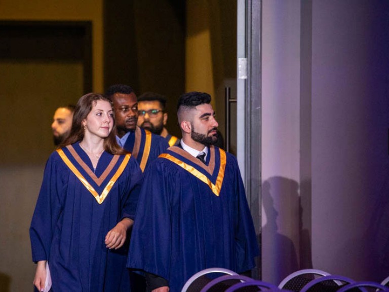 Graduates enter the ceremony hall