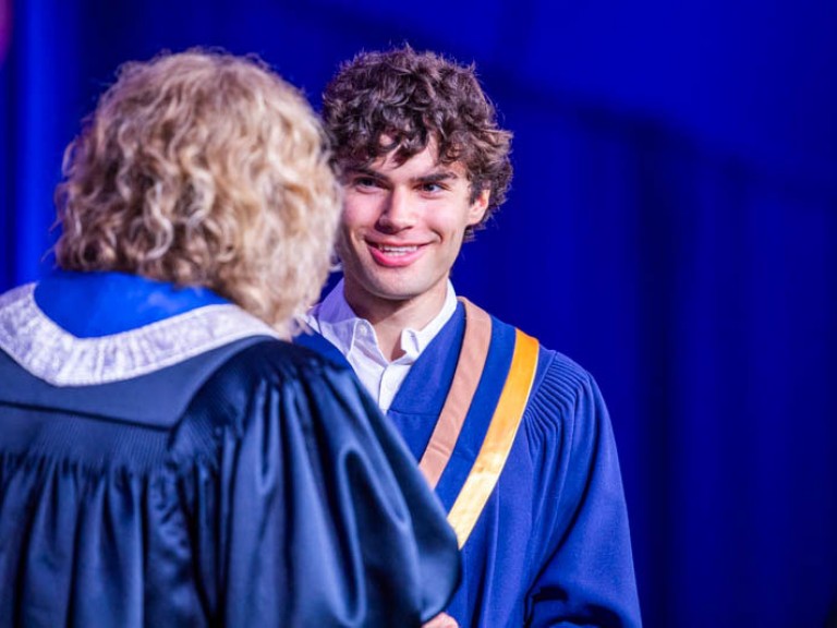 Graduate smiles at Humber president