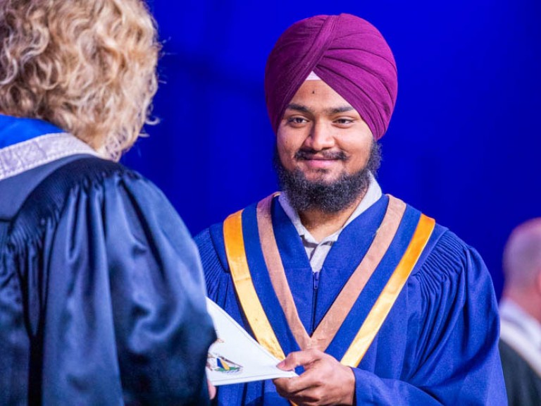 Graduate accepts their certificate