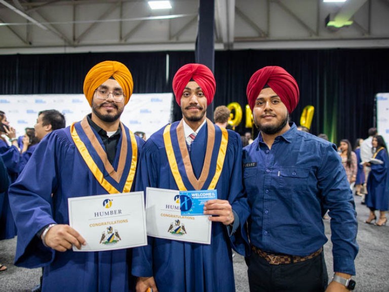 Three graduates take photo together
