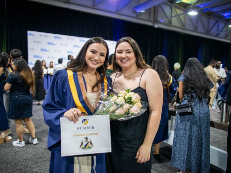 Graduate takes photo with her sister
