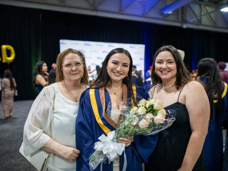 Graduate takes photo with her sister and mom