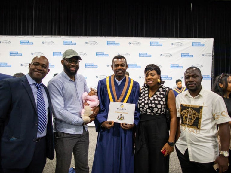 Graduate takes photo with four family members