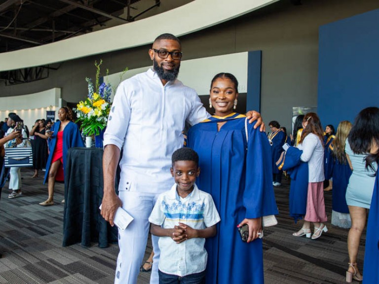 Graduate poses with two family members