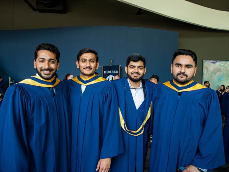 Four graduates take photo together