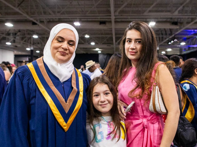 Graduate takes photo with two family members