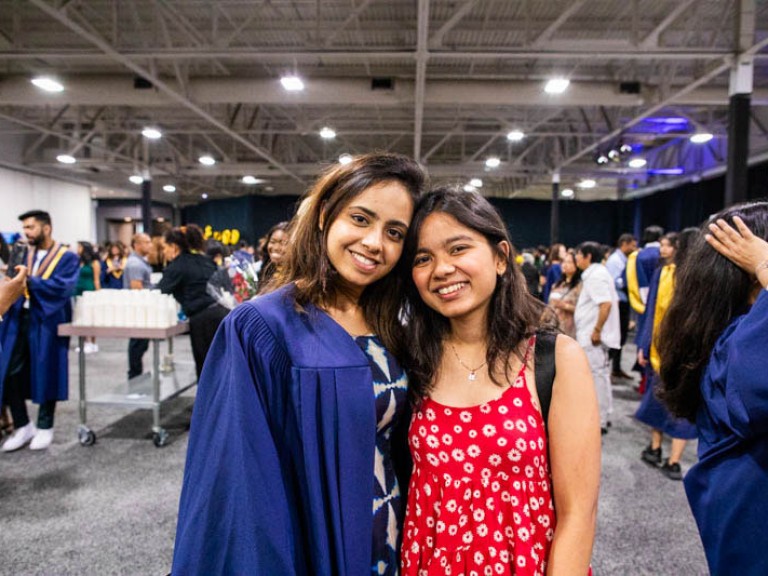 Graduate takes photo with guest