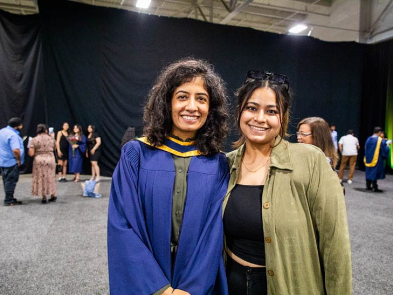 Graduate poses with family member