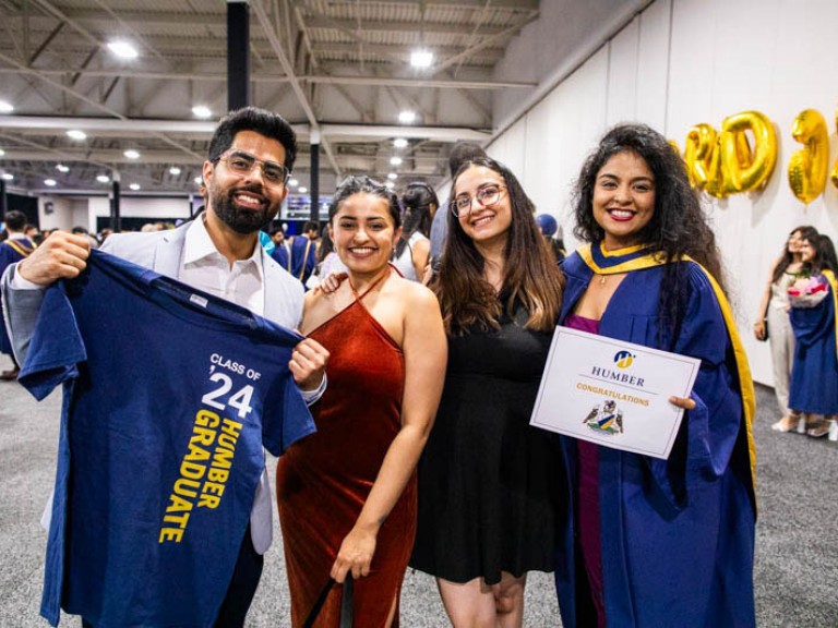 Graduate poses with three guests